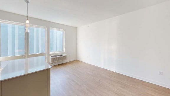an empty living room with white walls and wood floors