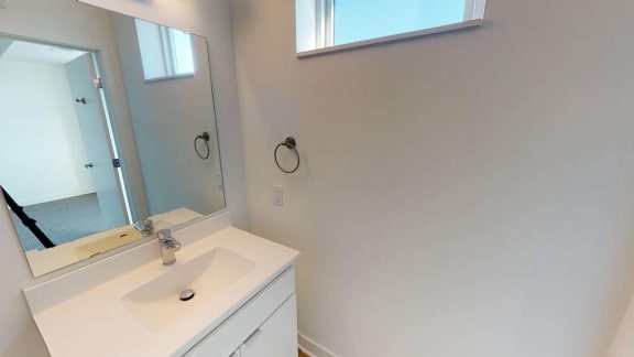 a white bathroom with a sink and a mirror
