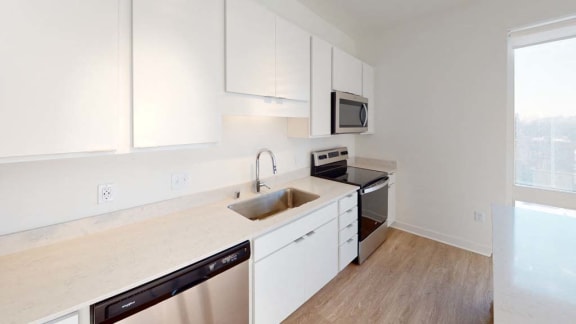 an empty kitchen with a sink and a microwave