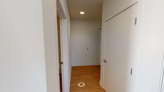 a hallway with a door to a bedroom and a closet