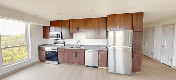 a kitchen with wooden cabinets and a stainless steel refrigerator