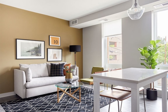 a living room with a white couch and a table