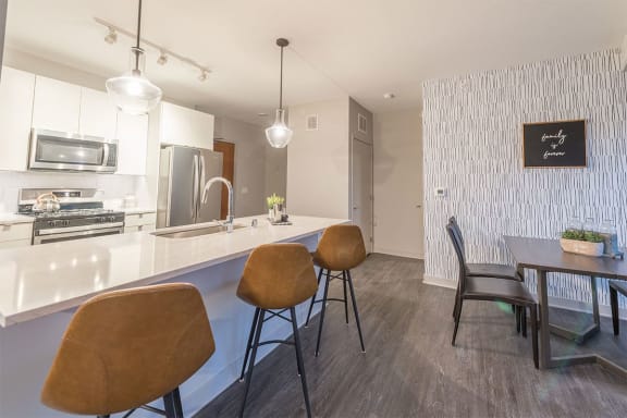 a kitchen and dining area with a table and chairs
