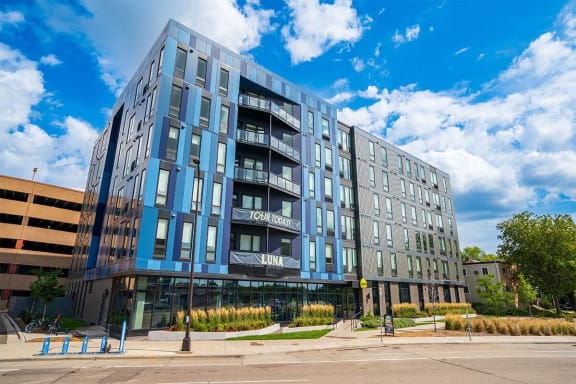 a large blue building with a street in front of it