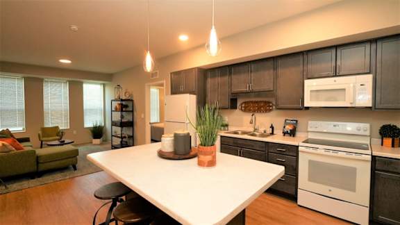a kitchen and living room with a white counter top