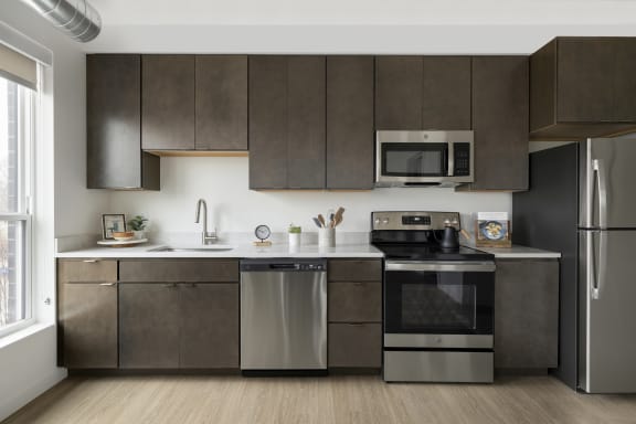a kitchen with stainless steel appliances and wooden cabinets
