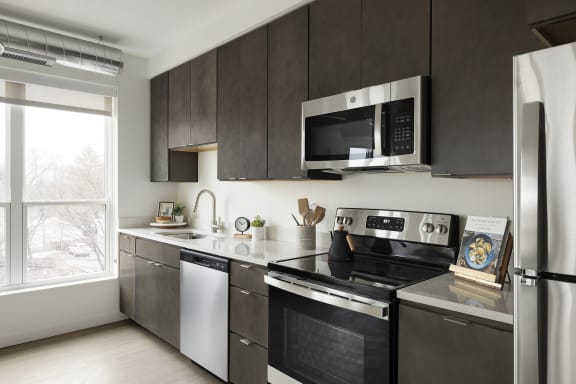 a kitchen with stainless steel appliances and a black and white stove