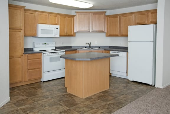 a kitchen with white appliances and wooden cabinets