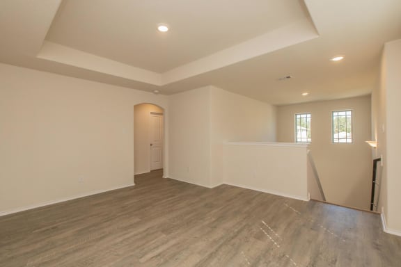 a bedroom with hardwood floors and white walls at The Village at Granger Pines, Conroe Texas