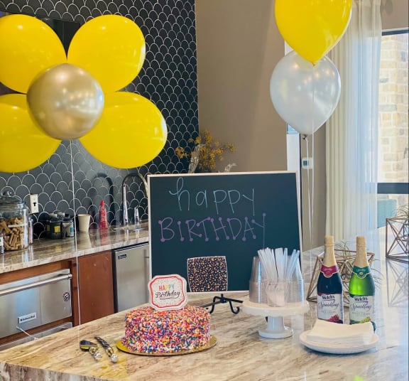 a birthday party with a cake and balloons at The Pointe at Valley Ranch Town Center, Texas, 77357