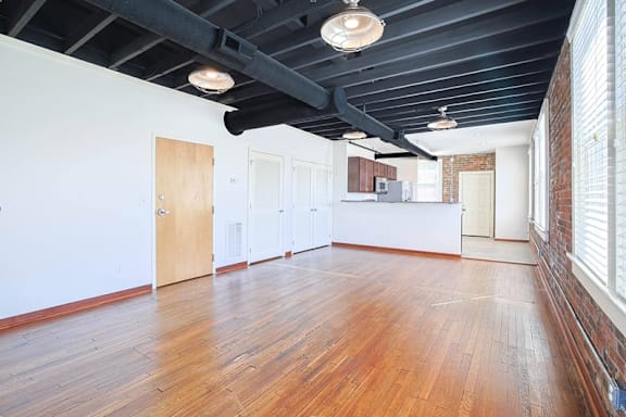 A room with wooden floors and white walls.