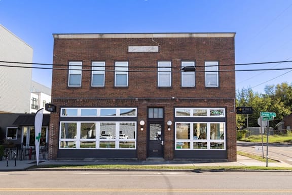 A brick building with a sign that says "Supreme" on it.