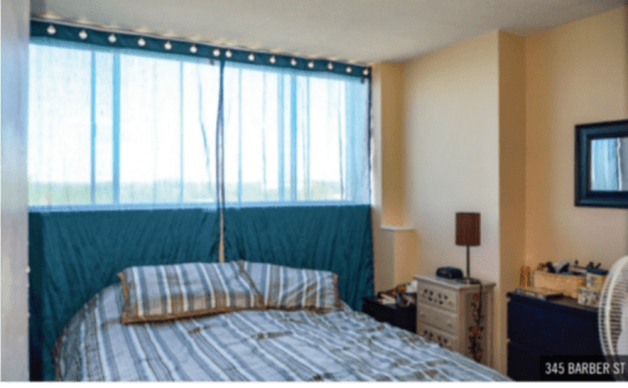 a bedroom with a bed and a large window