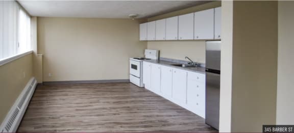 a kitchen with white cabinets and stainless steel appliances