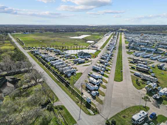 A bird's eye view of a residential area with houses and cars.
