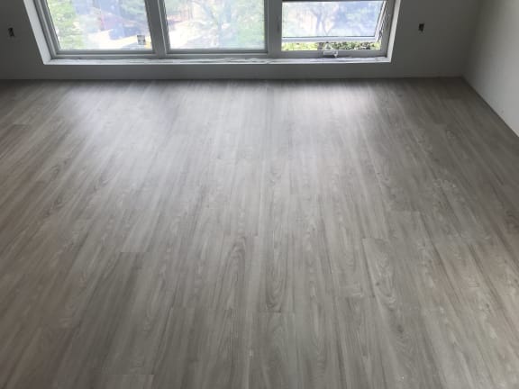 an image of a room with a hardwood floor