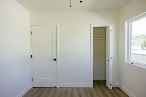 A room with two doors and a window.