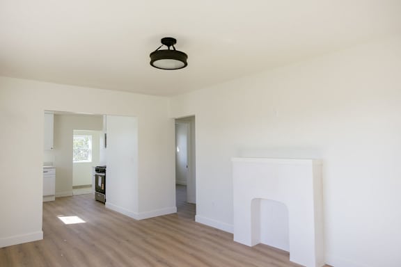 A white room with a fireplace and a light fixture.