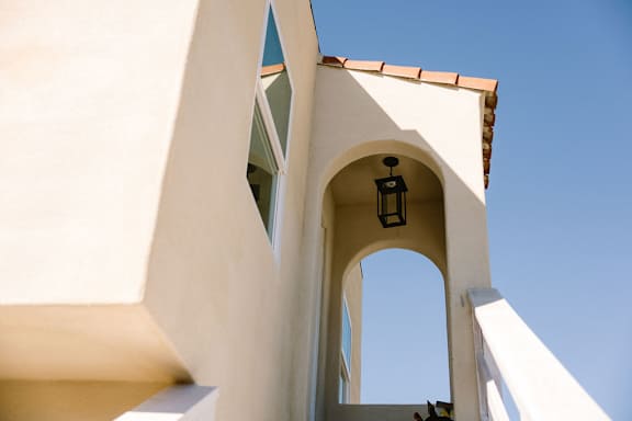 A white building with a blue sky in the background.