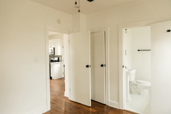 a doorway into a bathroom with a toilet and a sink