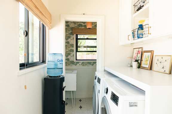 A small laundry room with a washer and dryer.