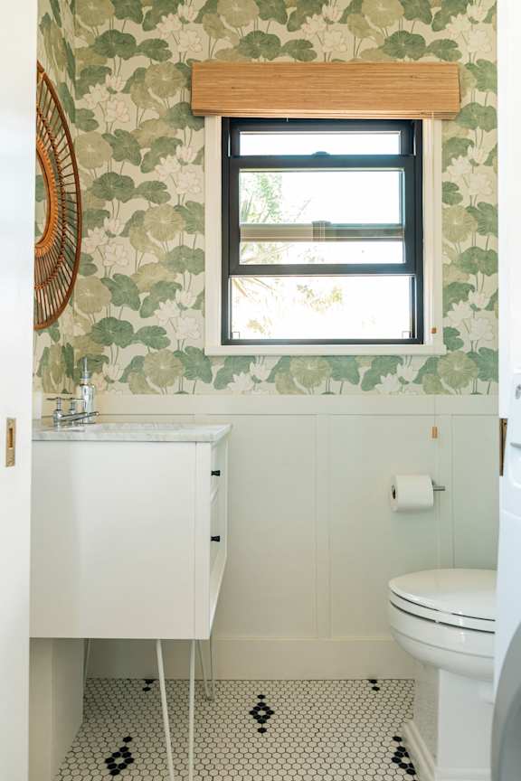 A bathroom with a white sink and toilet.
