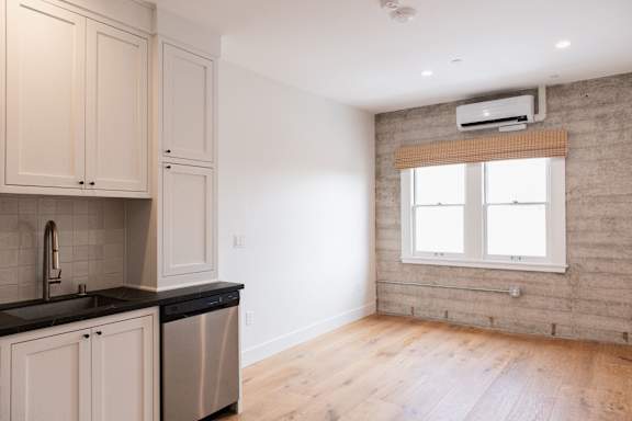 A kitchen with wooden cabinets and a black countertop.