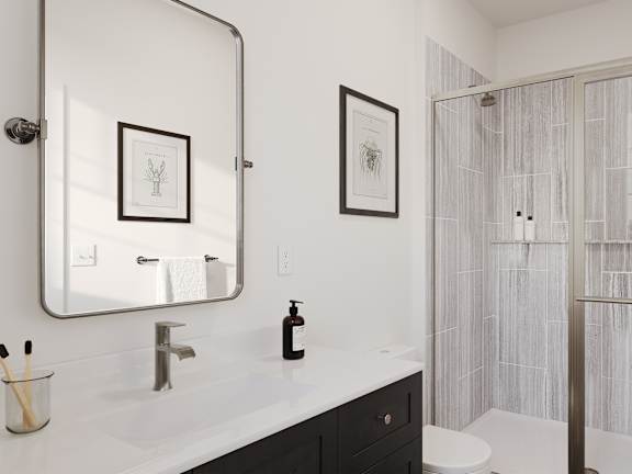 a bathroom with a shower and a sink and a mirror