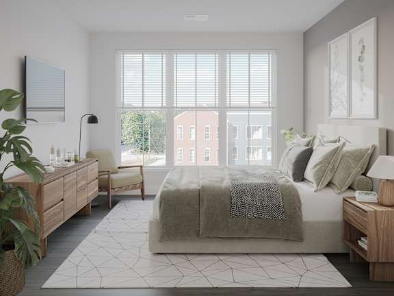 a bedroom with a bed and a large window