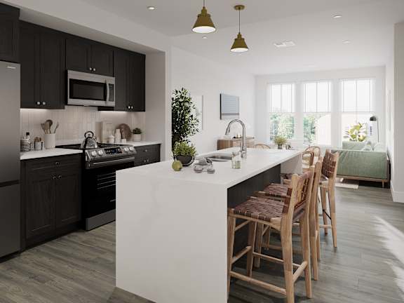 a kitchen with black cabinets and a white island with chairs