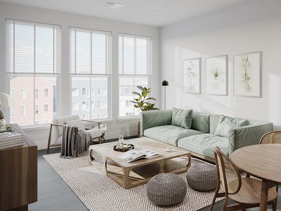 a living room with a green couch and a coffee table