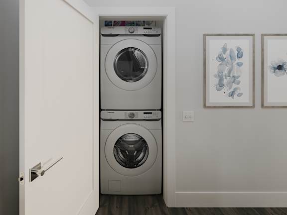 a front loader washer and dryer in a room with a door open