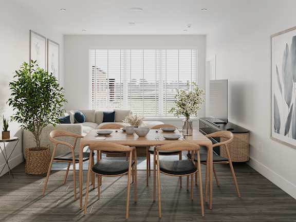 a dining room with a wooden table and chairs and a large window