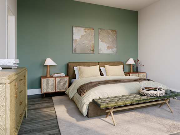 a bedroom with a bed and two paintings on the wall
