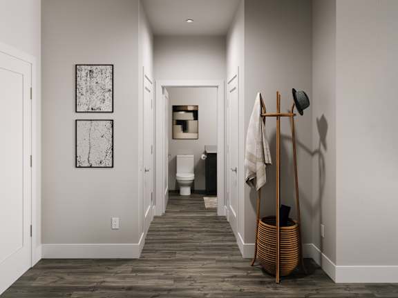 a hallway with a towel rack and a toilet