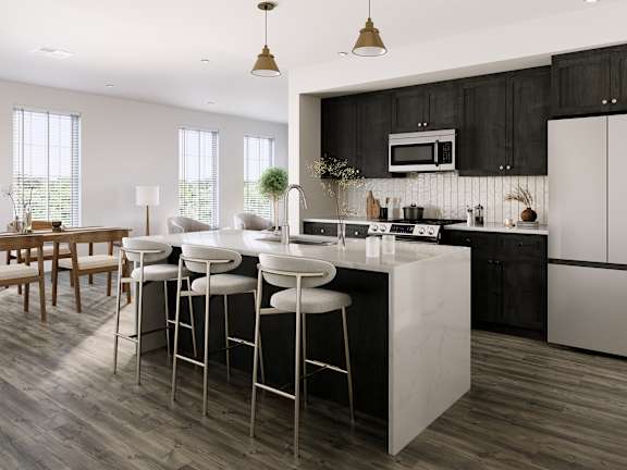 a kitchen with a large island with bar stools and a dining room with chairs