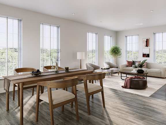 a living room and dining room with a table and chairs