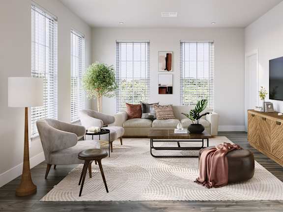 a living room with a couch and chairs and a rug