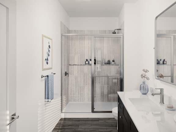 a white bathroom with a shower and a sink