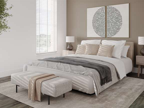 a bedroom with a bed and a painting on the wall