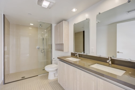 a bathroom with a toilet and a sink and a shower