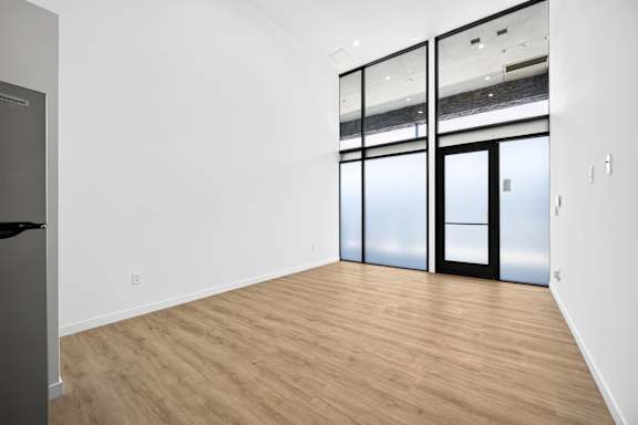 A room with a wooden floor and a glass door.