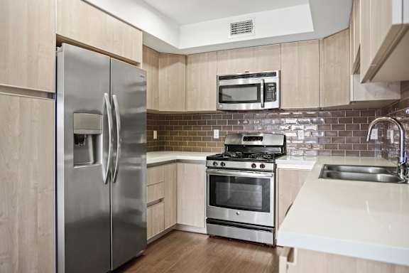 Kitchen with Gas Range and Side by Side Refrigerator