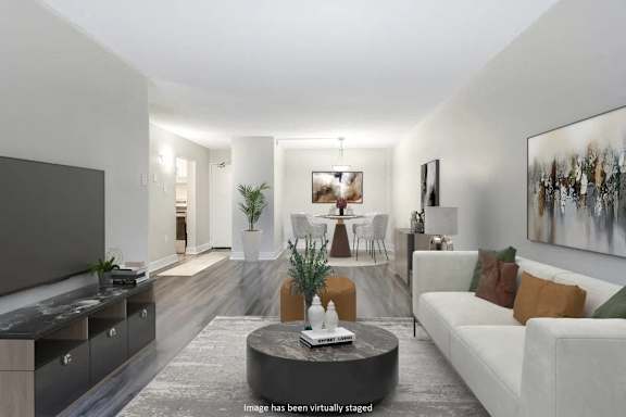 Living room with white furniture and a tv  at Platts Crossing, London, ON, N6H 4P4