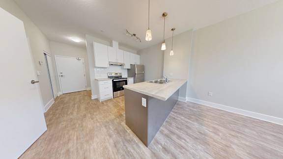 A kitchen area with a counter and cabinets.
