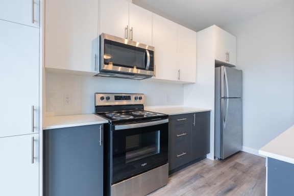a kitchen with stainless steel appliances and white cabinets