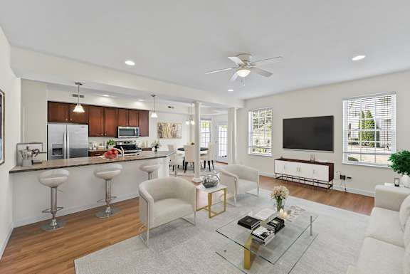 A modern living room with a bar area and a kitchen in the background.
