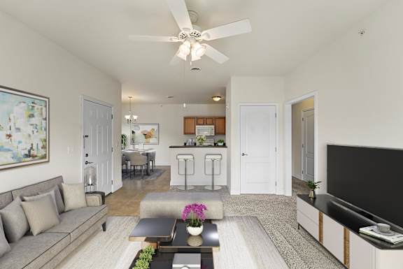 a living room and kitchen with a ceiling fan