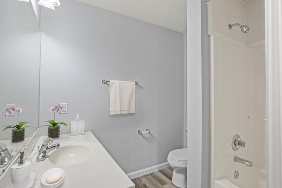 A white sink and toilet in a bathroom.