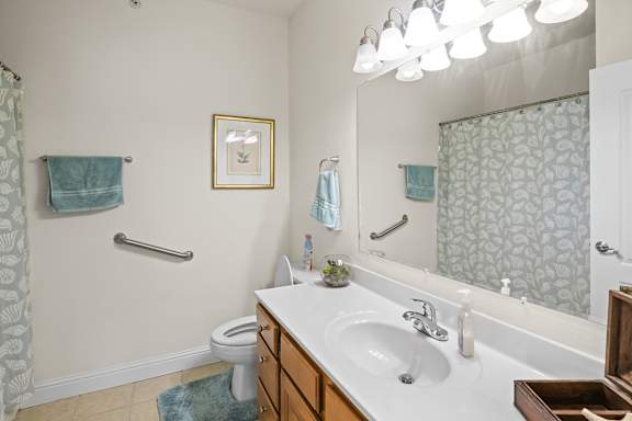 A bathroom with a white sink and a mirror.